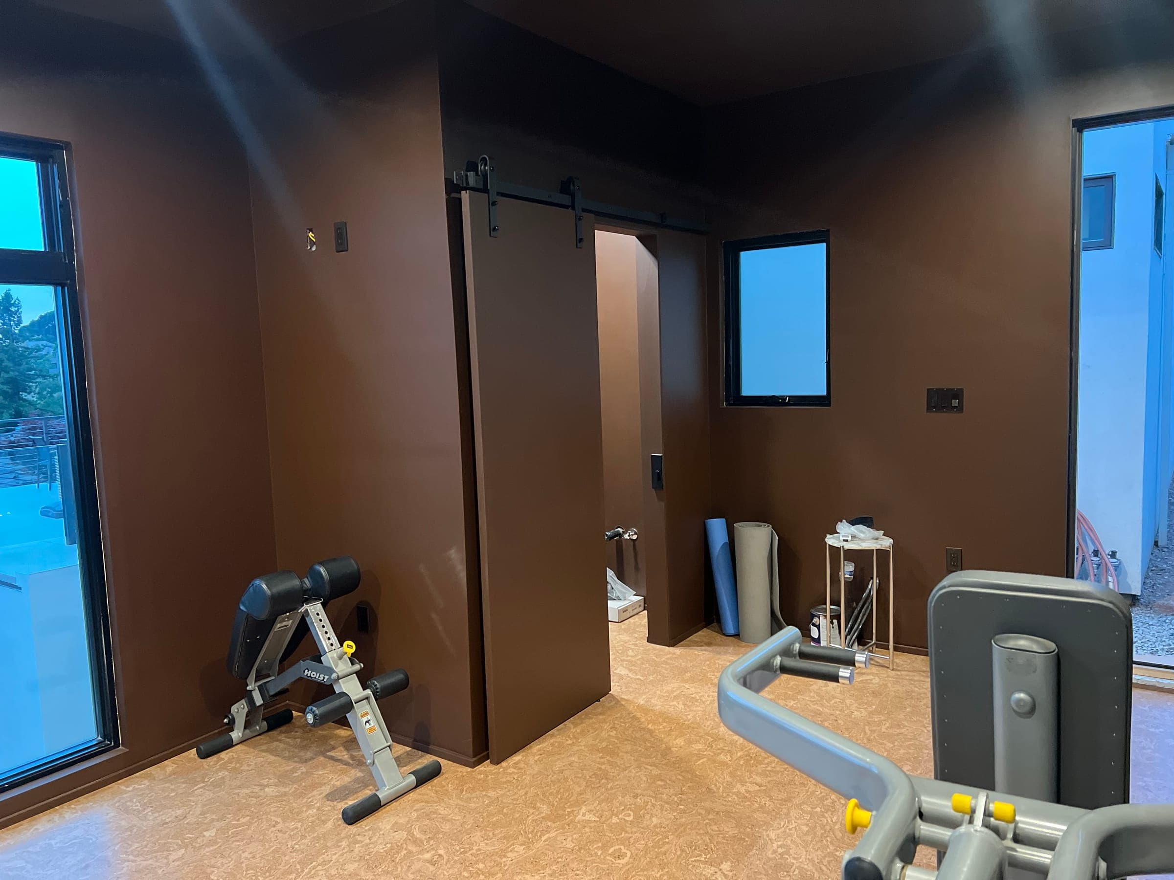 Finished home gym inside the ADU with sliding barn door and cork flooring