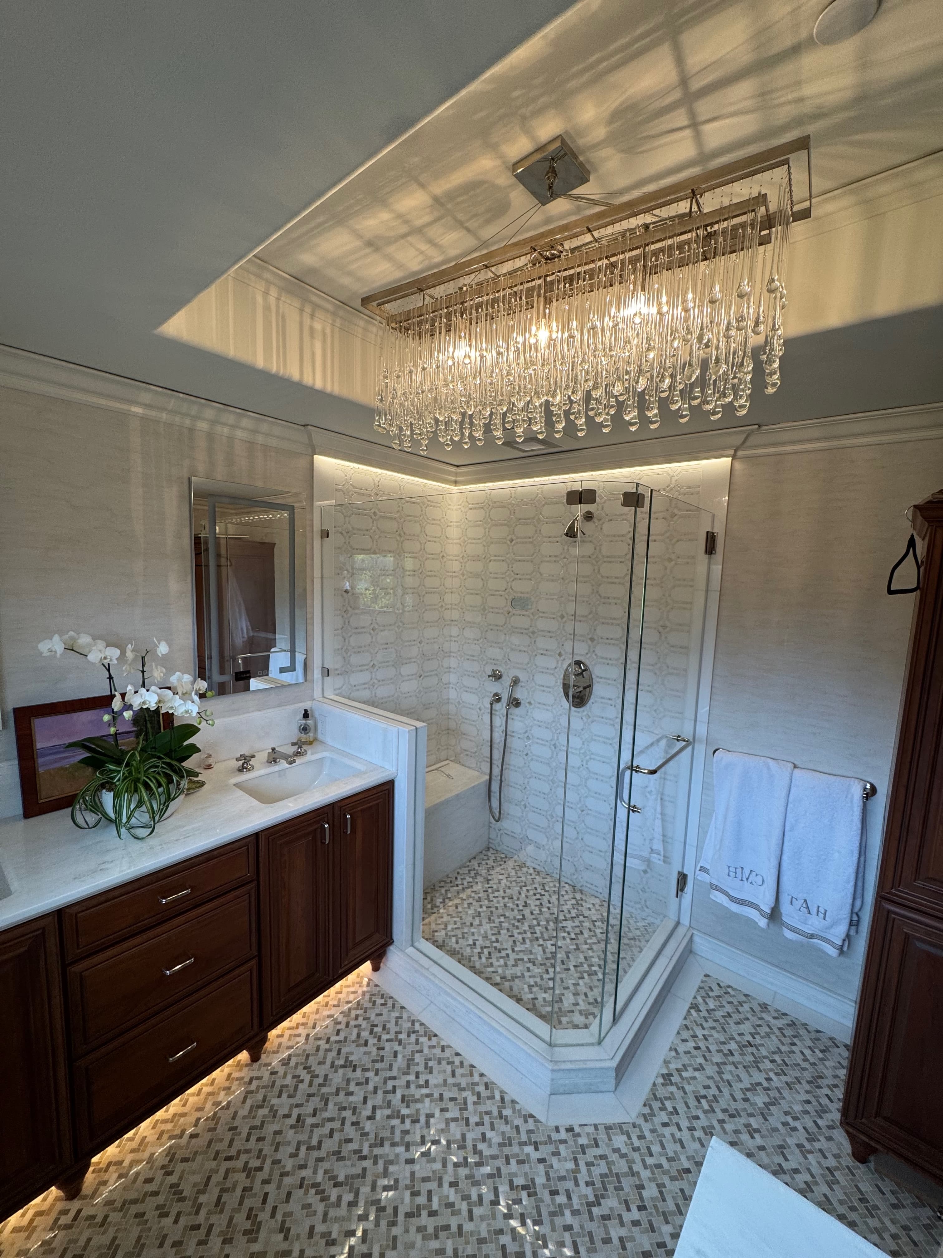 Elegant master bathroom with crystal chandelier