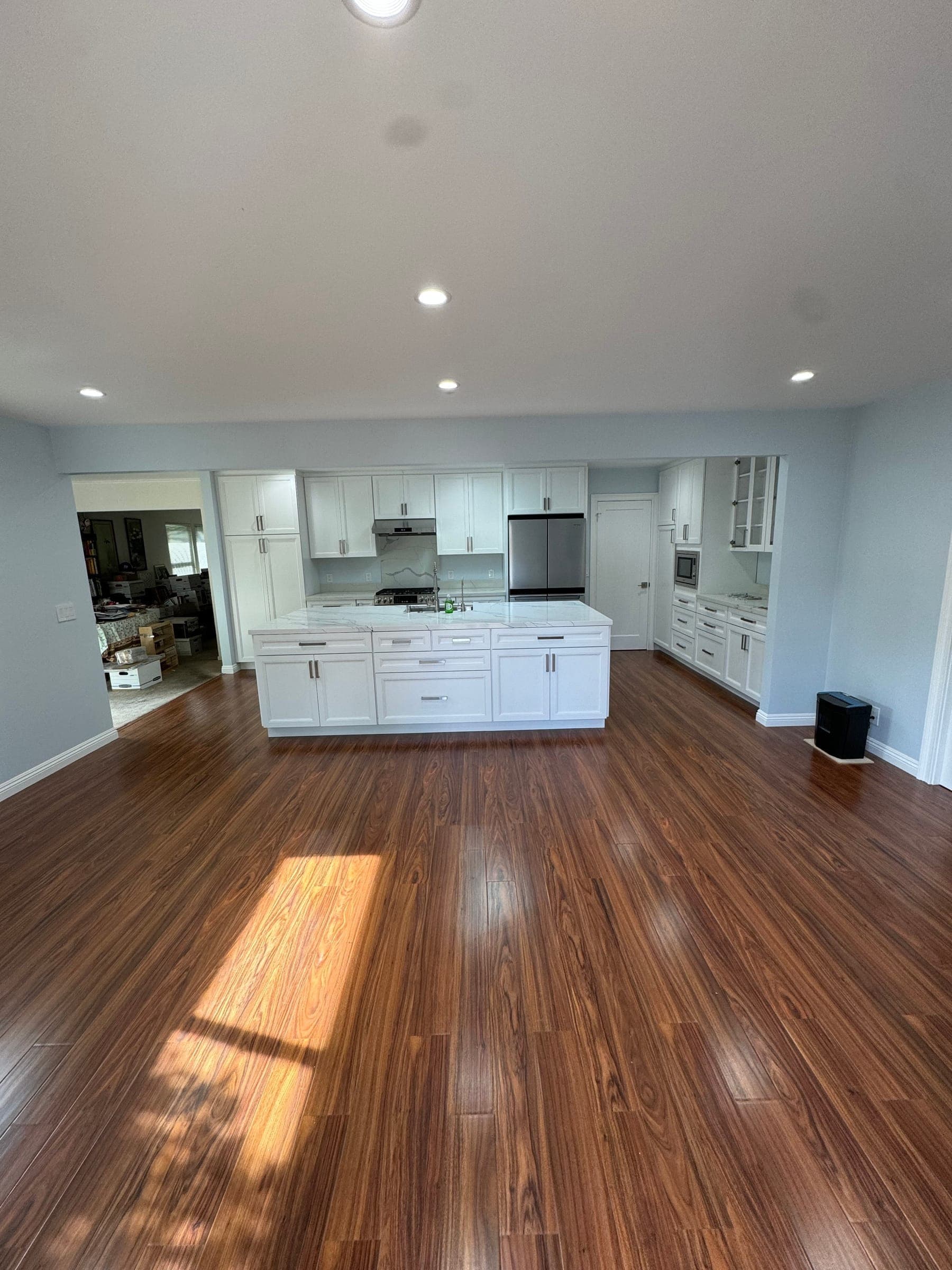 Open-concept kitchen and dining area with new wide-plank flooring